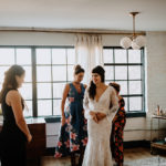 Family helps bride into wedding gown for Philadelphia wedding
