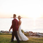 bride and groom looking at Chesapeake Bay sunset