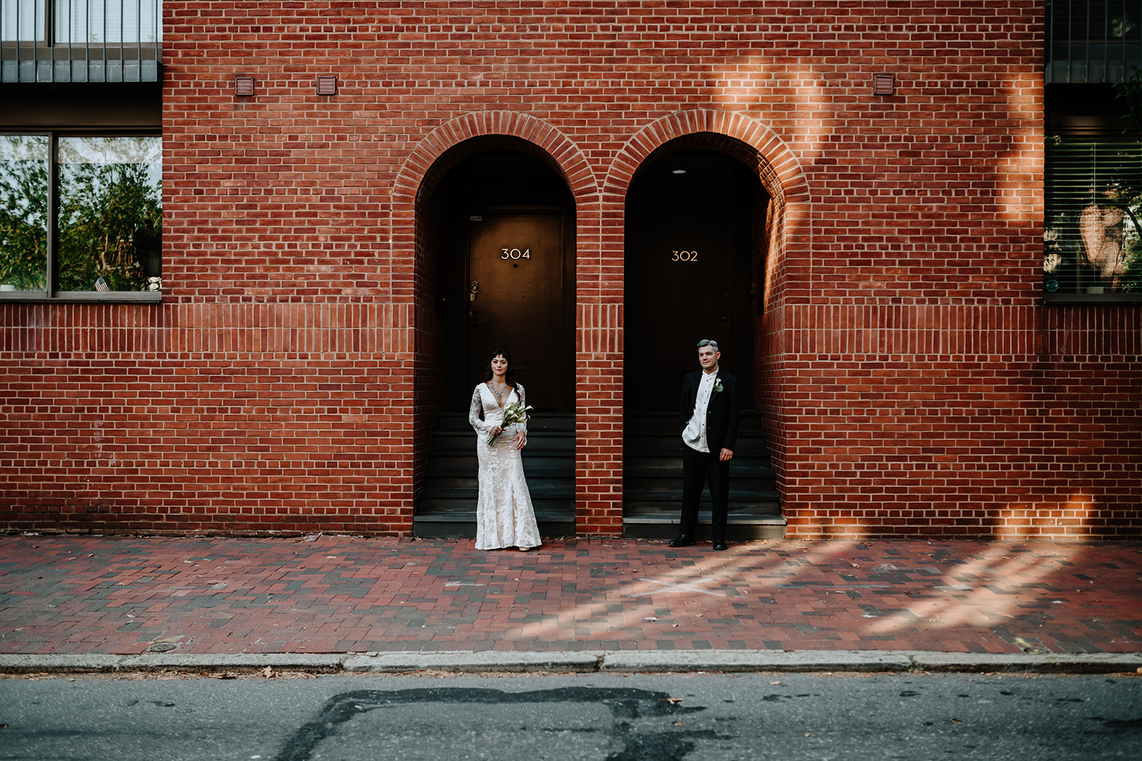 bride and groom in front of brick building society hill philadelphia