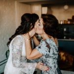 Philadelphia bride and mother of groom share a kiss before wedding