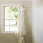 wedding gown hanging on window